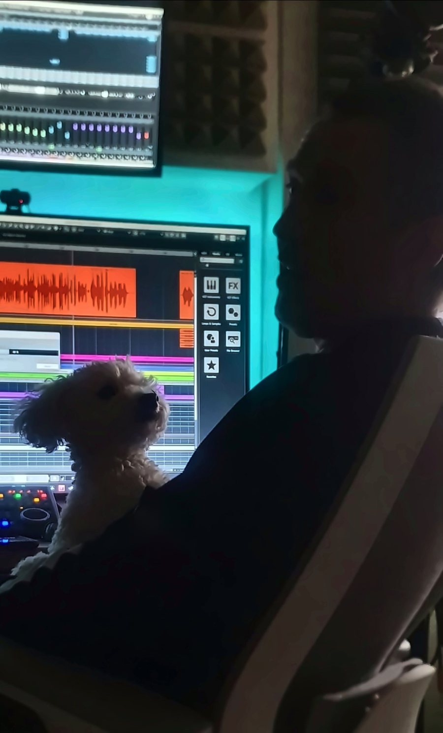 Lunar Rescue at the mixing desk in the studio, with his dog on his lap